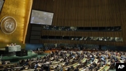 In this photo provided by the United Nations, Syrian Ambassador to the United Nations Bashar Ja'afari can be seen on the monitor as he addresses the U. N. General Assembly, Thursday, Feb. 16, 2012 at United Nations Headquarters.