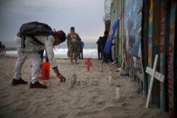 Candles are placed next to the border fence that separates Mexico from the United States, in memory of migrants who have died during their journey toward the U.S., in Tijuana, Mexico, June 29, 2019.