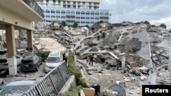 Emergency personnel work at the site of a partially collapsed building in Miami Beach, Florida, U.S., June 24, 2021. 