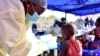 A Congolese health worker administers ebola vaccine to a child at the Himbi Health Center in Goma, July 17, 2019.