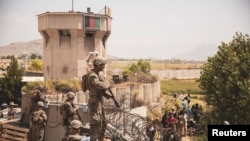 U.S. Marines stand guard at an Evacuee Control Checkpoint at Hamid Karzai International Airport, Kabul, Afghanistan, in this photo taken on August 20, 2021. Sgt. Victor Mancilla/U.S. Marine Corps/Handout via REUTERS THIS IMAGE HAS BEEN SUPPLIED BY A THIR