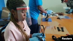 FILE: Tanzanian workers in Dar es Salaam fabricate face shields for health professionals and others. Picture taken 5.7.2020