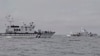 In this image from a video released by Taiwan Coast Guard Administration, a Taiwanese Coast Guard Administration ship, left, chases a Chinese Coast Guard ship near Kinmen County, Taiwan, July 11, 2024. 