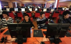 FILE - People use computers at an Internet cafe in Hefei, Anhui province, Sept. 26, 2010.