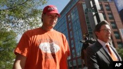 Glenn Adam Chin, left, a former supervisory pharmacist at the New England Compounding Center, walks with his attorney Paul Shaw, right, after appearing in federal court, Thursday, Sept. 4, 2014.