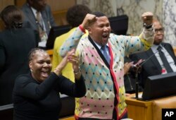 FILE - Mandla Mandela, centre, grandson of the late Nelson Mandela, in parliament August 8, 2017, in Cape Town, South Africa.