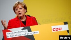 German Chancellor Angela Merkel, a top candidate of the Christian Democratic Union Party (CDU) for the upcoming general elections, speaks at an election rally in Schwerin, Germany, Sept. 19, 2017. 