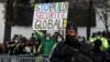 French gendarmes stand guard as people attend a demonstration against the so-called Global Security bill, near the National Assembly in Paris, France, Nov. 24, 2020.