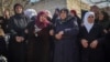 Relatives and neighbors mourn during the funeral procession for Syrian security force members killed in clashes with loyalists of ousted President Bashar Assad in coastal Syria, in the village of Al-Janoudiya, March 8, 2025.