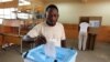 FILE: A man casts his ballot at a voting station in Kicolo, Luanda, Angola. Taken 8.31.2012