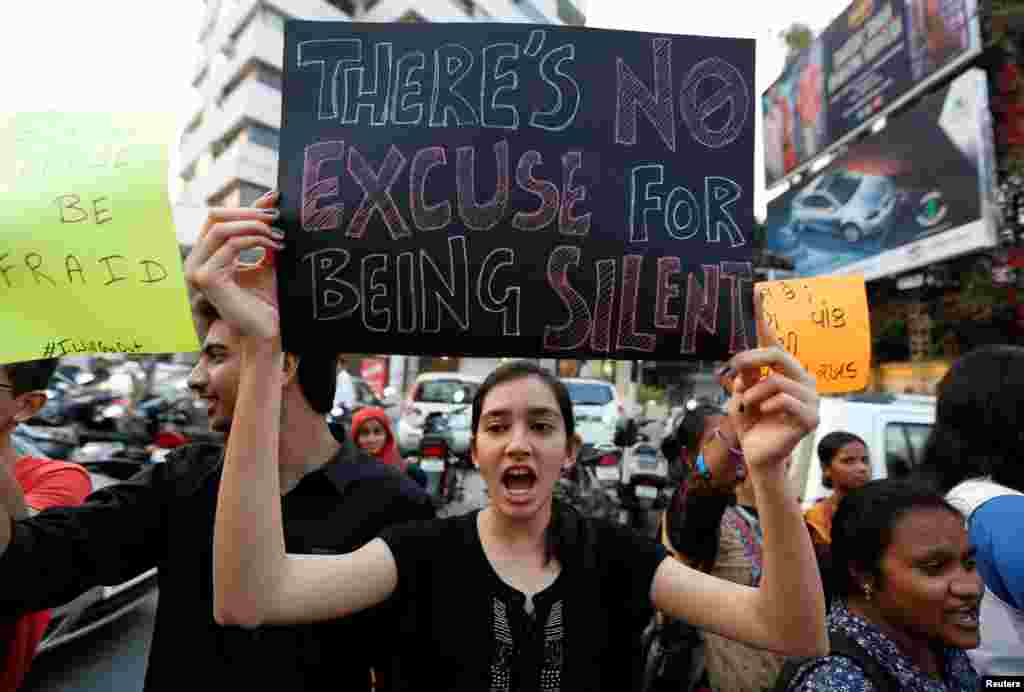 A woman shouts slogans as she takes part in the #IWillGoOut rally, to show solidarity with the Women's March in Washington, along a street in Ahmedabad, India, Jan. 21, 2017.