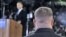 A Secret Service agent stands near then-presidential candidate Barack Obama [background] at a rally in Norfolk, Virginia, October 2008 (file photo) 