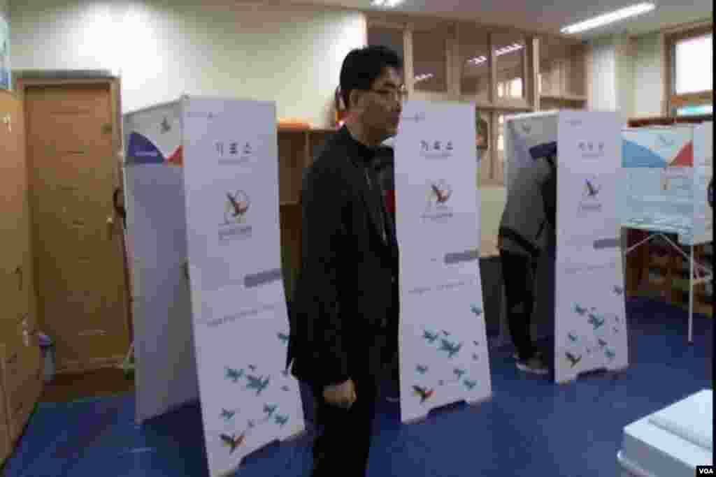 A voting official watches over polling for South Korea's election Tuesday.