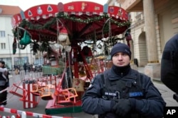 A police officer patrols a Christmas market where a car drove into a crowd in Magdeburg, Germany, Dec. 21, 2024.