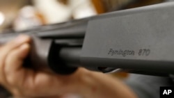 FILE - In this March 1, 2018, photo, the Remington name is seen etched on a model 870 shotgun at Duke's Sport Shop in New Castle, Pa.