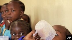 School children drink porridge at the Raila Education Center, a part of a school feeding program in Kibera slum, Nairobi (file photo)