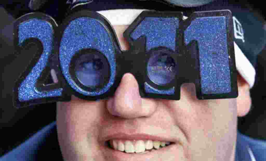 Jeff Singer from Kansas sits in Times Square as he waits for the evening's New Year's Eve celebrations to begin in New York, 31 Dec 2010