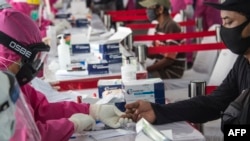 Warga mendapatkan rapid test gratis di Surabaya, 4 Juni 2020 (Foto oleh Juni Kriswanto / AFP)