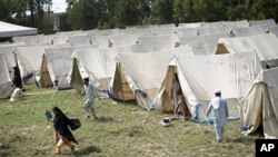 Displaced Pakistanis living a tent camp set up by the army on the outskirts of Nowshera, Pakistan, 2 Aug 2010.