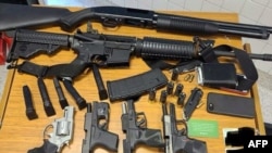 This image released by the Atlanta Police Department on March 25, 2021, shows weapons taken from a suspect arrested at a Publix Supermarket in Atlanta, Ga., March 24, 2021.