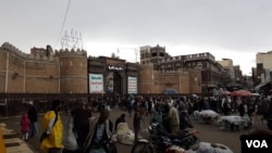 People shop outside the gates to the Old City in Sana'a on May 7, 2020.