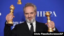 Sam Mendes poses in the press room with the awards for best director, motion picture and best motion picture drama for "1917" at the 77th annual Golden Globe Awards at the Beverly Hilton Hotel on Sunday, Jan. 5, 2020, in Beverly Hills, Calif. (AP…