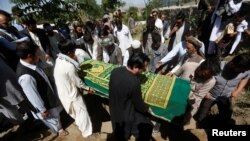 FILE - Afghans take part in a burial ceremony of Afghan journalist Zabihullah Tamanna, in Kabul, Afghanistan, June 7, 2016. Tamanna was killed along with David Gilkey of U.S. National Public Radio in a Taliban attack on an Afghan army unit they were traveling with.