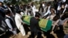 FILE - Afghans take part in a burial ceremony of Afghan journalist Zabihullah Tamanna, in Kabul, Afghanistan, June 7, 2016. 