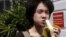 FILE - Amos Yee eats a banana as he arrives to the State Courts for a pre-trial conference in Singapore, April 17, 2015. 