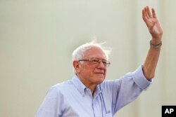 Democratic presidential candidate Sen. Bernie Sanders, I-Vt., waves to supporters as he arrives at a rally at Santa Monica High School Memorial Greek Amphitheater in Santa Monica, Calif., July 26, 2019.