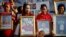 Anti-government ''red shirt'' protesters hold pictures of killed friends, relatives and late Italian photographer Fabio Polenghi, Bangkok's, May 19, 2011.