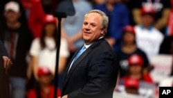 FILE - Interior Secretary David Bernhardt joins President Donald Trump, not pictured, as he speaks at a rally in Colorado Springs, Colo., Feb. 20, 2020.