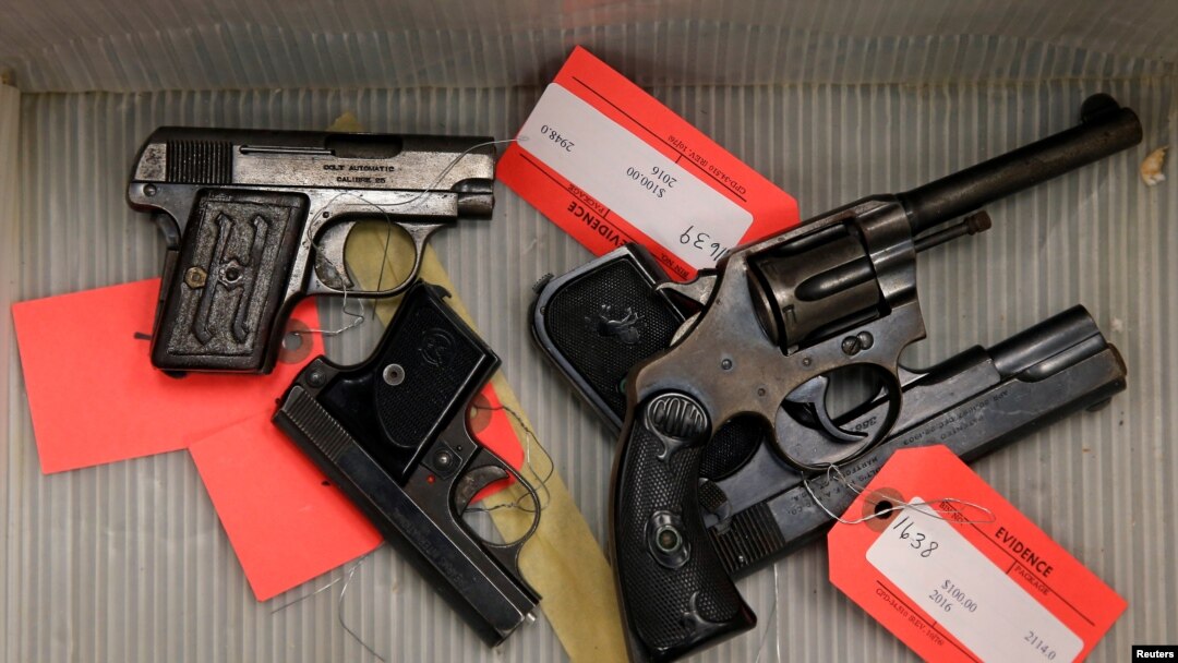 FILE - Handguns given up by the public as part of a gun turn-in where a gift card is given for every firearm turned over to Chicago Police are seen in a box at Universal Missionary Baptist Church in Chicago, Illinois, May 28, 2016.