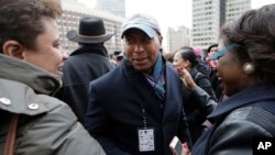 FILE - Former Massachusetts Governor Deval Patrick, center, greets people in a crowd, in Boston, Massachusetts, April 2, 2018.