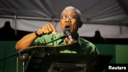 FILE - Guyanan President David Granger, pictured in late 2014, is criticizing "a persistence of aggressive behavior, hostile behavior towards Guyana" on the part of Venezuela.