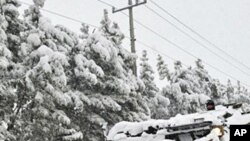 A South Korean army armored vehicle clears snow in Pohang, east of Seoul, February 14, 2011