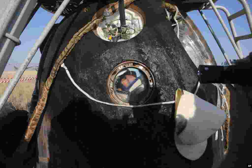 Russian cosmonaut Oleg Artemiev looks out of the Soyuz capsule. Sept. 11, 2014.