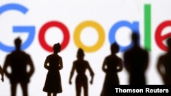 FILE - Small figures are seen in front of Google logo in this photo illustration.