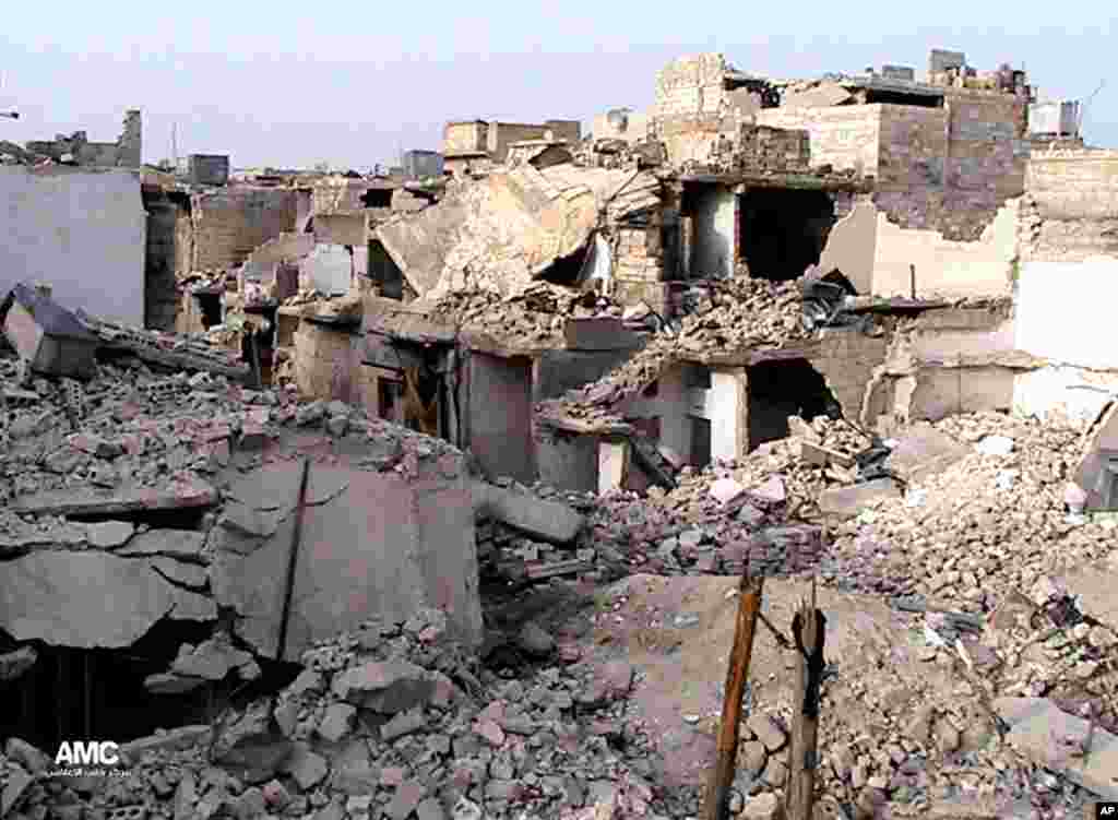 This citizen journalism image provided AMC shows homes destroyed by Syrian government airstrikes and shelling in Karam Tarab near Aleppo International Airport, Syria, July 2, 2013.