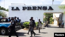 Nicaraguan police take part in a raid at the offices of La Prensa, the only national newspaper, after President Daniel Ortega's government opened customs fraud and money laundering investigations against the publication, in Managua, Aug. 13, 2021. 