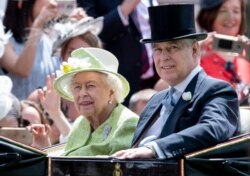 FILE - Britain's Queen Elizabeth II and Prince Andrew attend at Royal Ascot Day Five at Ascot Racecourse in Britain, June 22, 2019.