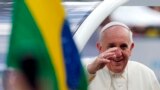 Pope Francis waves to the faithful as he arrives at Sao Joaquim Palace in Rio de Janeiro, July 26, 2013.&nbsp;