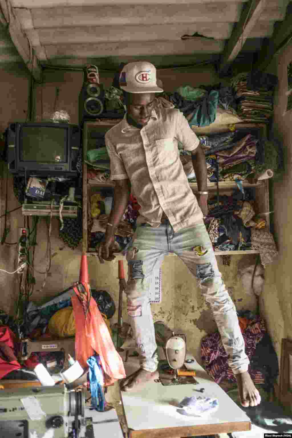 A tailor works in Dakar&#39;s Niary Tally neighborhood, the working class area where Dakar Fashion Week held their &quot;Street Parade&quot; fashion show this year, June 29, 2017. The show is free and takes place in an open and public area each year as part of Dakar Fashion Week&#39;s events.