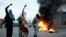 Opposition supporters shout as they burn tires during a protest to demand a referendum to remove President Nicolas Maduro in San Cristobal, Venezuela, May 18, 2016.