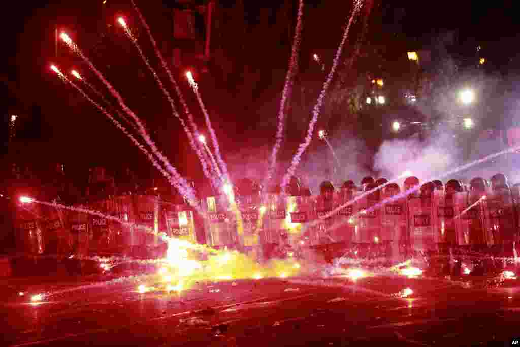 Demonstrators use firecrackers against police during a rally against the government&#39;s decision to suspend negotiations on joining the European Union for four years, outside the parliament&#39;s building in Tbilisi, Georgia.