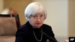 FILE - Federal Reserve Chairwoman Janet Yellen attends Board of Governors meeting at the Federal Reserve in Washington, Sept. 3, 2014.