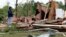 A friend of the owner reviews the remains of a storm damaged house in Morton, Miss., April 19, 2019, following a possible tornado touchdown Thursday afternoon.