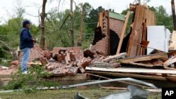 A friend of the owner reviews the remains of a storm damaged house in Morton, Miss., April 19, 2019, following a possible tornado touchdown Thursday afternoon.