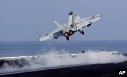 In this picture taken on Nov. 21, 2016, a U.S. Navy fighter jet takes off from the deck of the U.S.S. Dwight D. Eisenhower aircraft carrier.