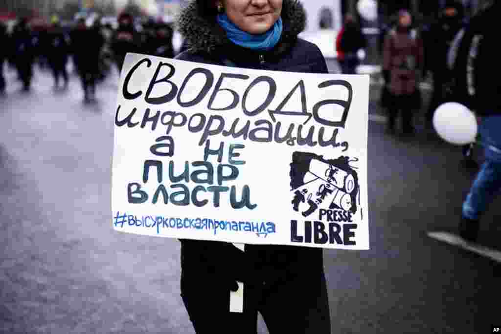 A protest sign reads, "Freedom of information not government PR," December 24, 2011. (VOA - Y. Weeks)